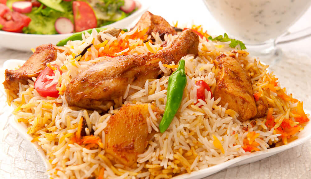 Chicken Dum Biryani with aromatic saffron rice and drumstick