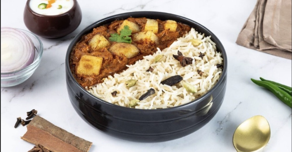 Bagara Rice served with paneer curry in terracotta bowls